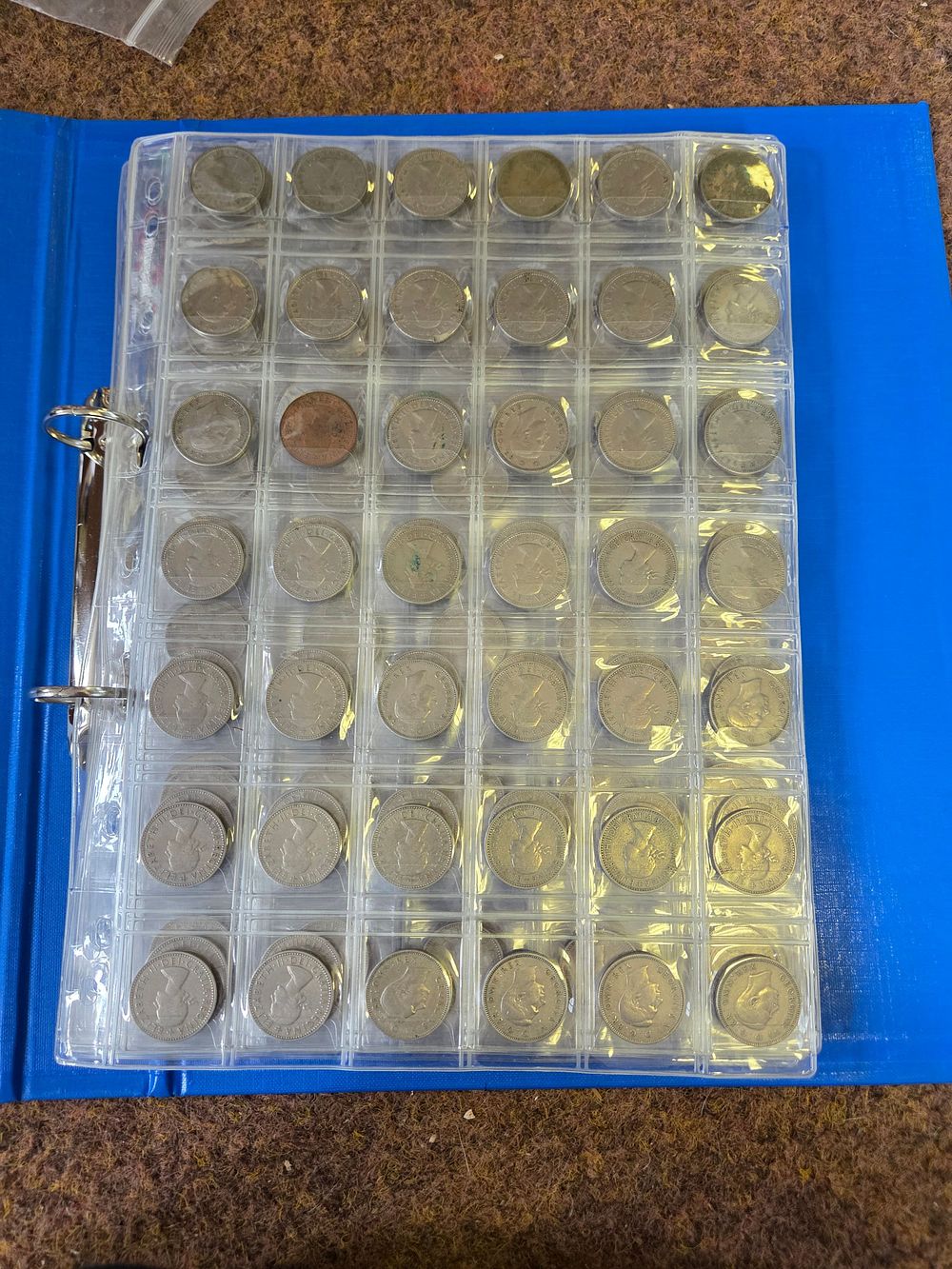 Lot 635 – A Collection of British and Commonwealth Coins in a Blue Album