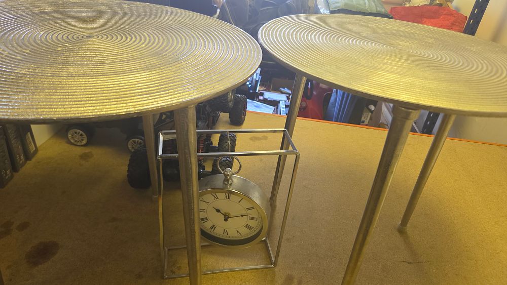 Lot 201 – A pair of contemporary textured aluminium side tables and a decorative framed table clock