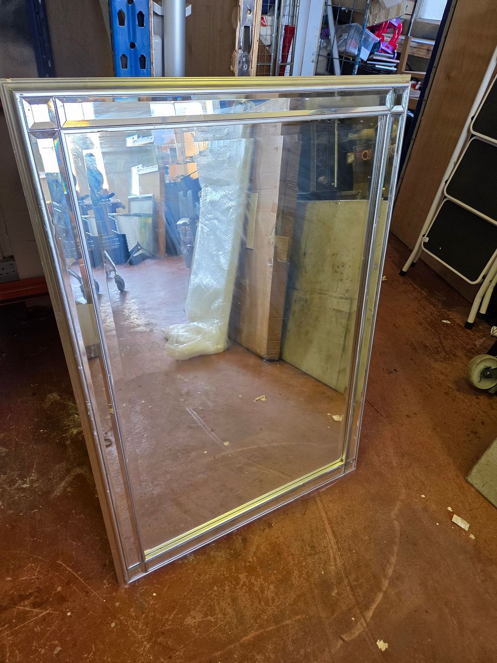 Lot 412 – A large contemporary rectangular wall mirror with a tiered bevelled frame