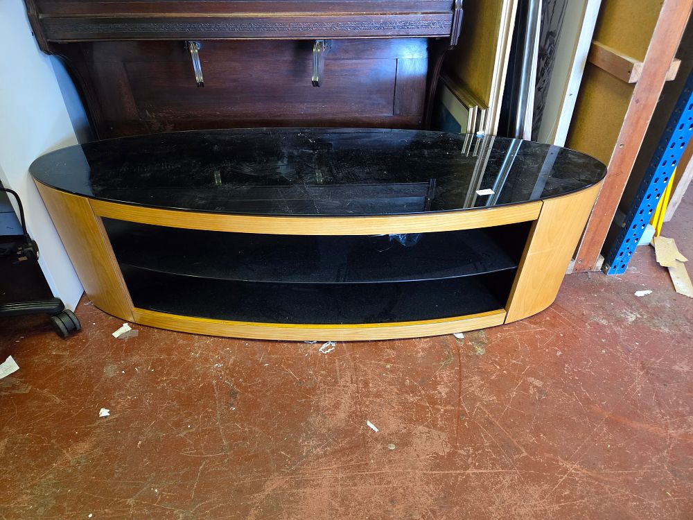 Lot 418 – A contemporary wood-effect and black glass oval television stand
