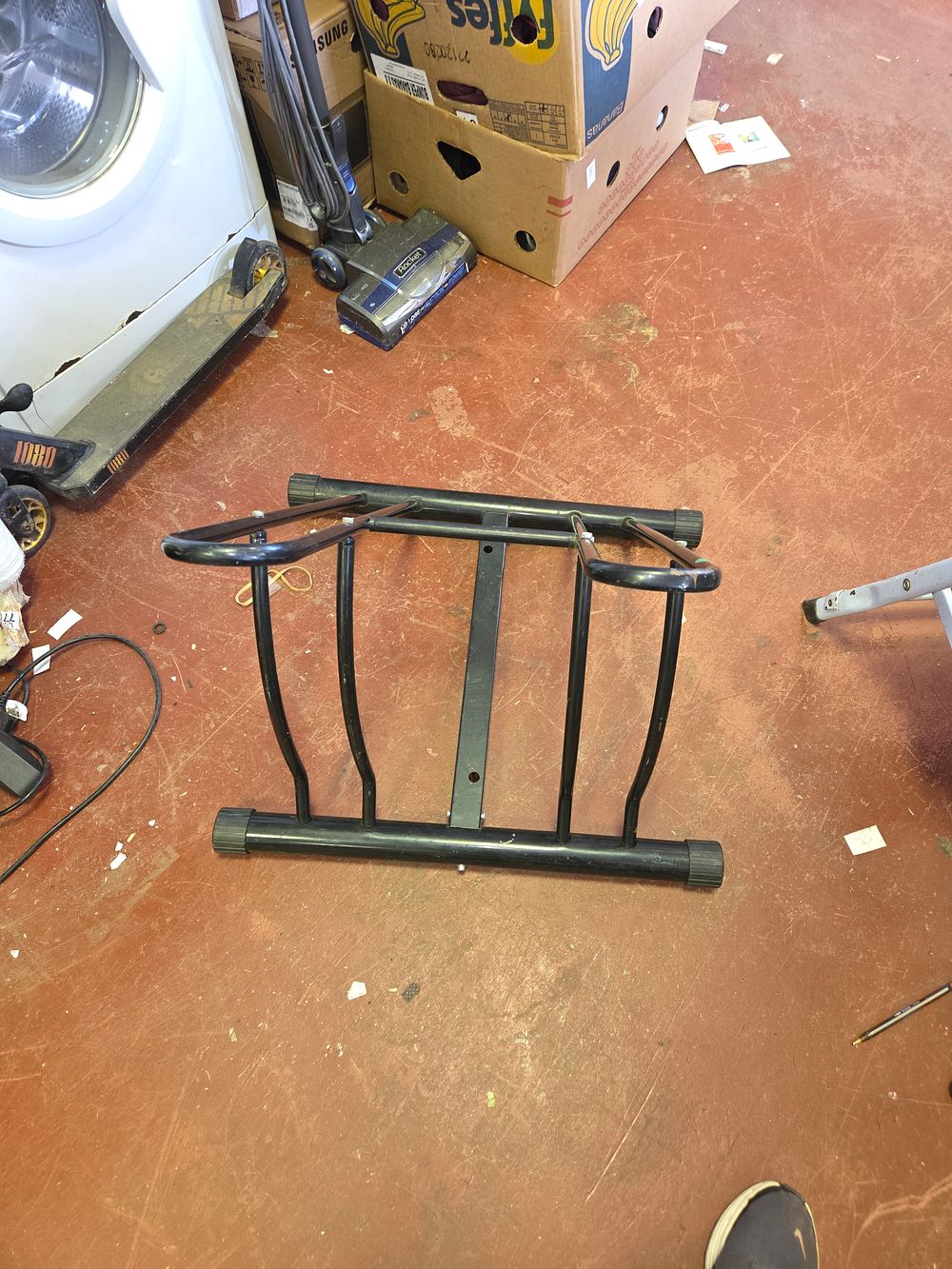 Lot 429 – A Double-Sided Black Powder-Coated Tubular Steel Bicycle Floor Rack