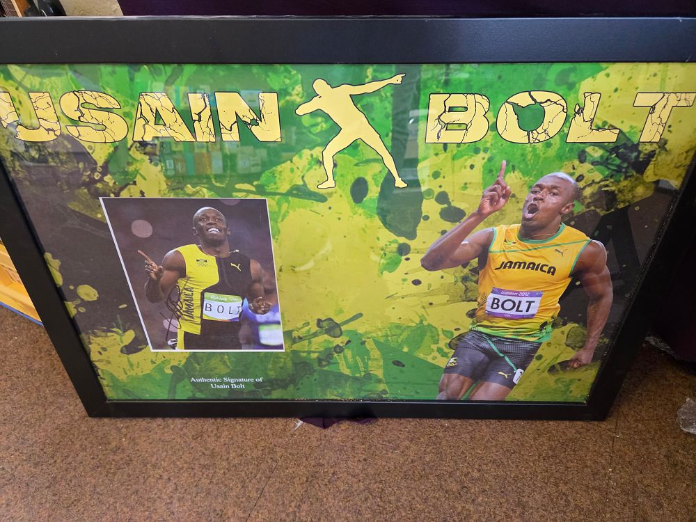 Lot 634 – Usain Bolt Signed and Framed Olympic Memorabilia Display with COA