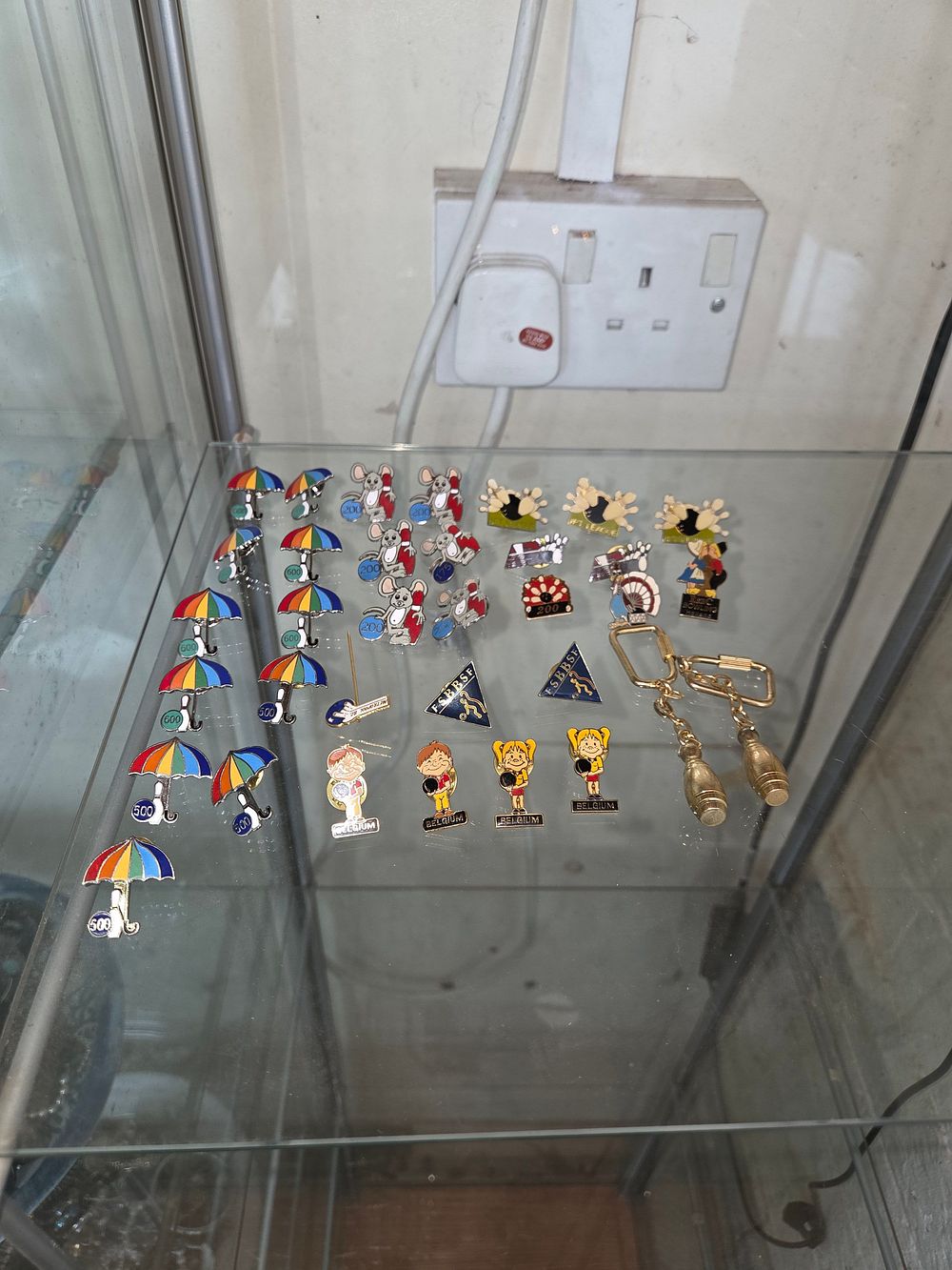 Lot 629 – A Collection of 25 Belgian Corporate Bowling Enamel Pins and Two Keychains