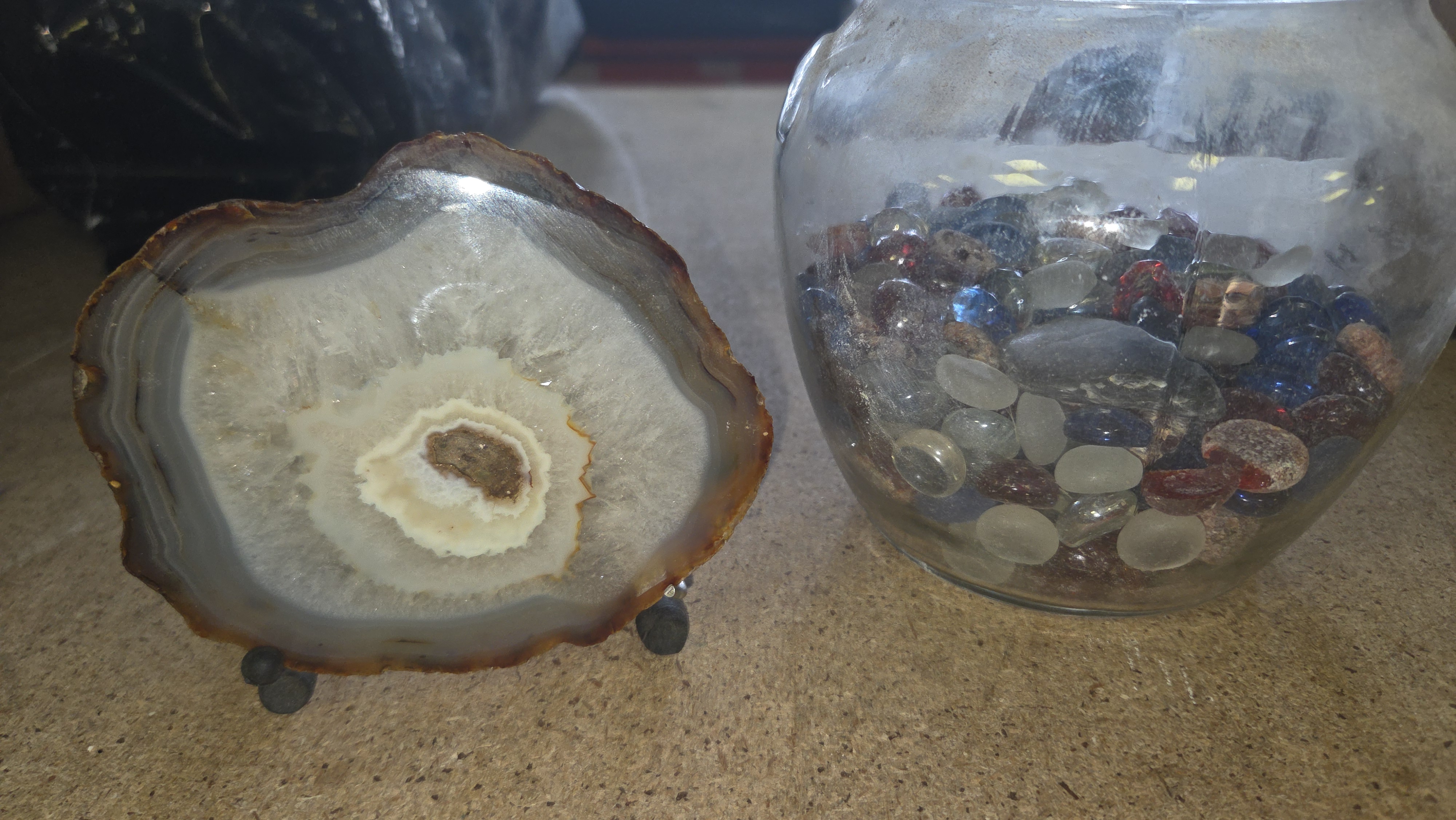 A Polished Banded Agate Specimen on Stand and a Jar of Decorative Pebbles
