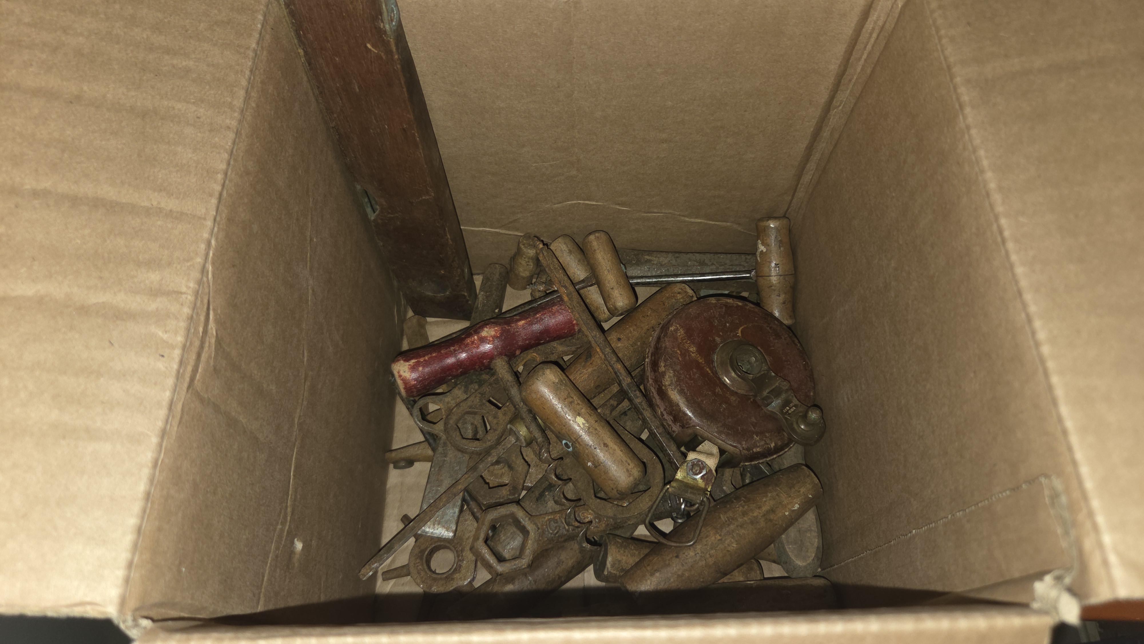 A Collection of Antique and Vintage Hand Tools Including a Leather-Cased Tape Measure and Wooden Spirit Level