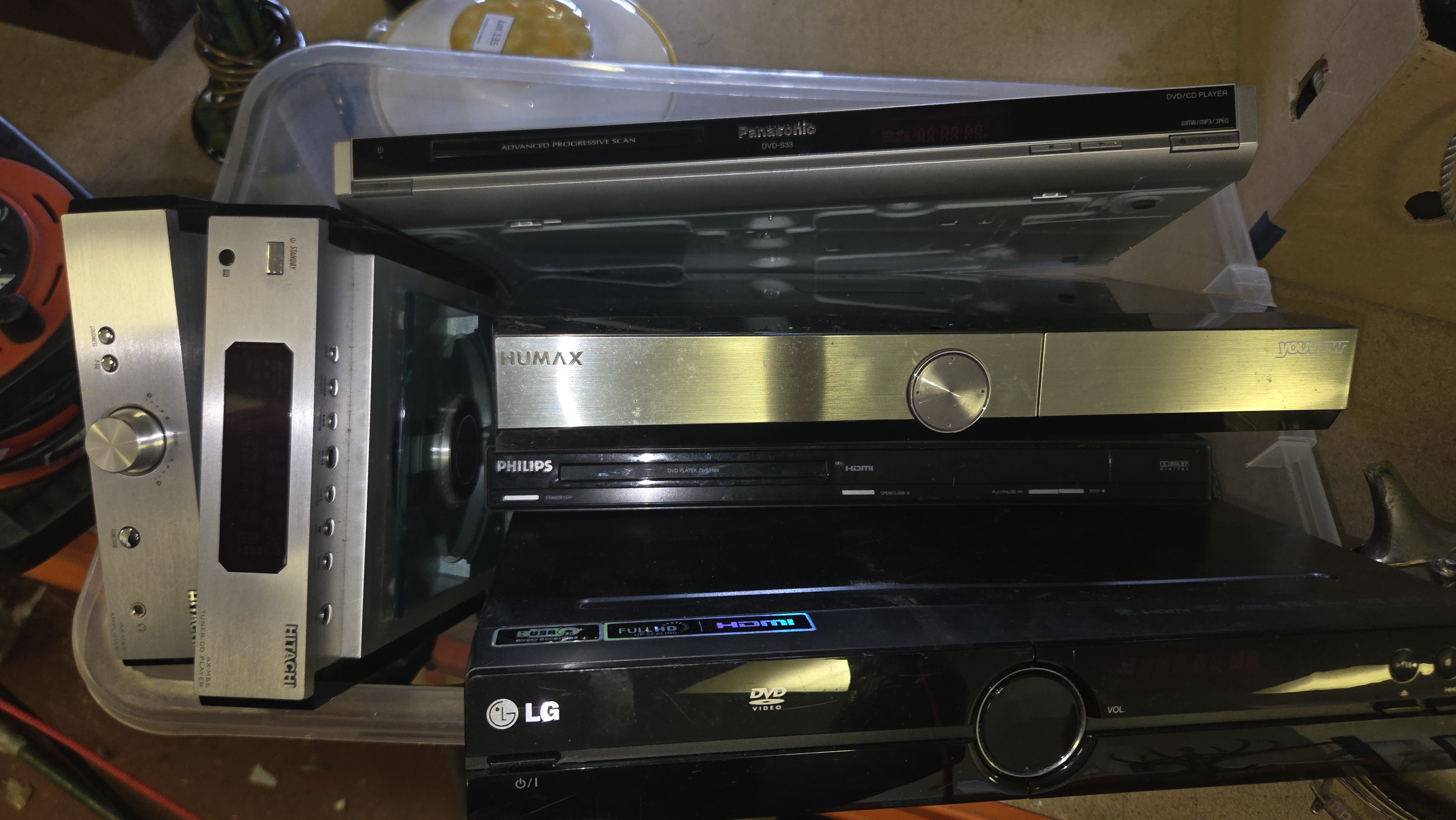 A Collection of Home Entertainment Electronics Including Panasonic, LG, and Philips DVD Players and Hitachi Micro Hi-Fi Components