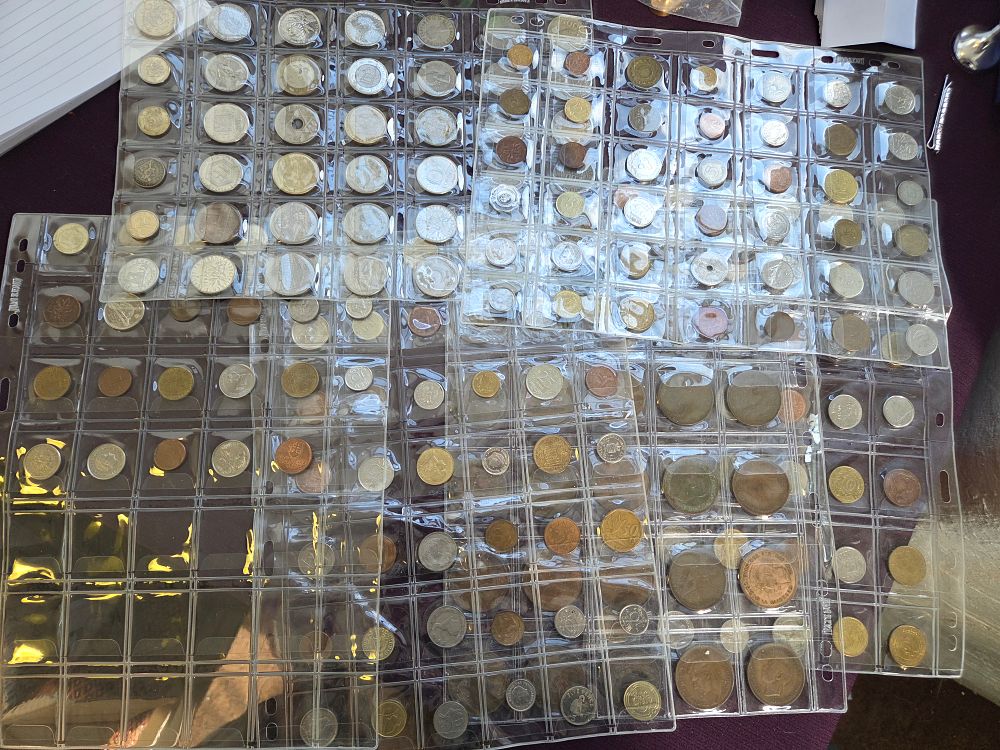 Lot 628 – A Collection of International and UK Coins in Storage Sheets
