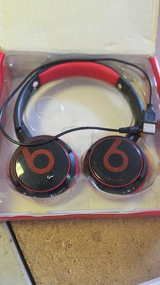 A Pair of Wireless Bluetooth Over-Ear Headphones with Charging Cable and Packaging