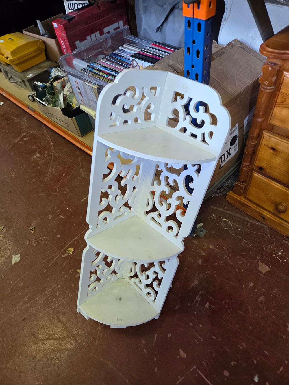 Lot 294 – A white-finished three-tier filigree carved corner shelving unit