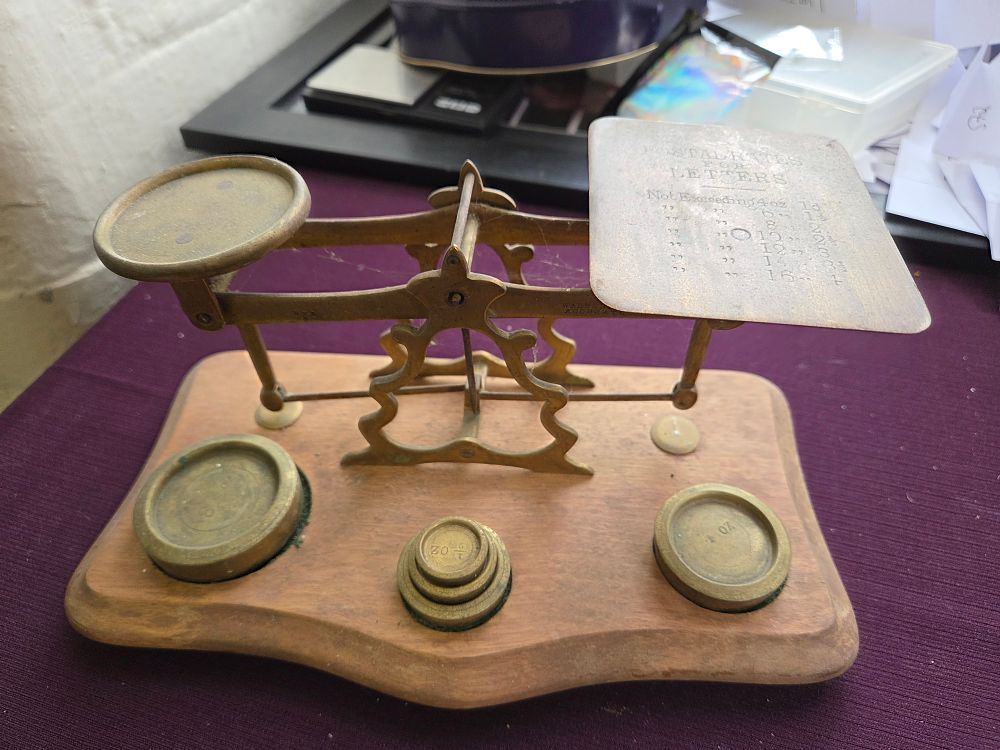 Lot 632 – A Set of Late Victorian Brass Postal Scales and Weights on a Mahogany Base