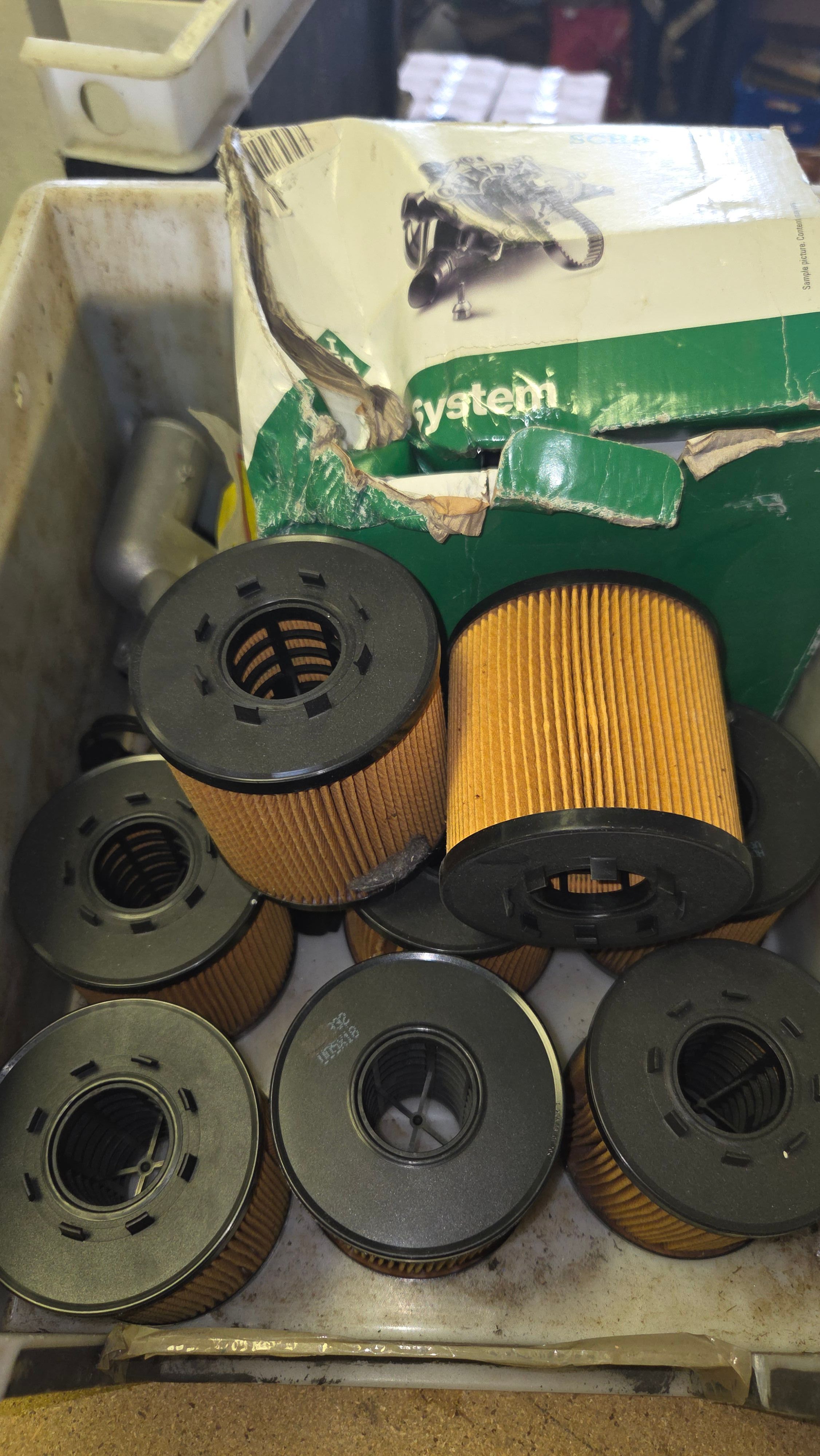 A Collection of Automotive Service Parts Including Seven Oil Filters and a Water Pump IP1618
