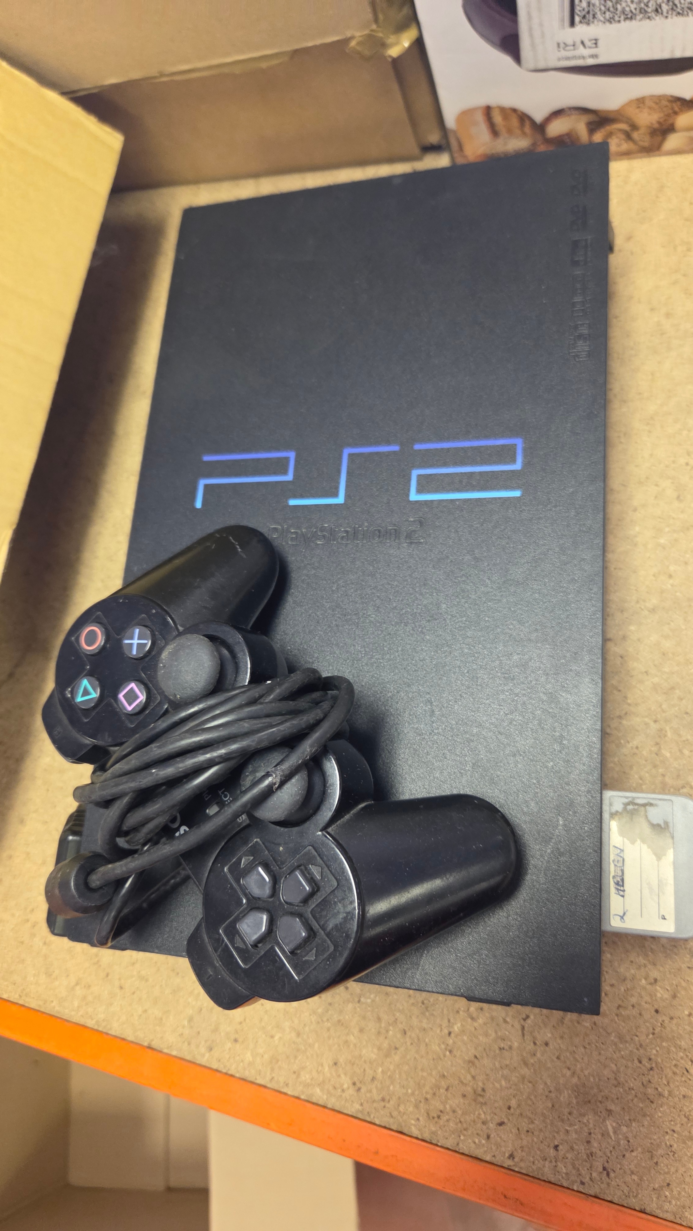Sony PlayStation 2 Console, DualShock 2 Controller and Memory Card powers on