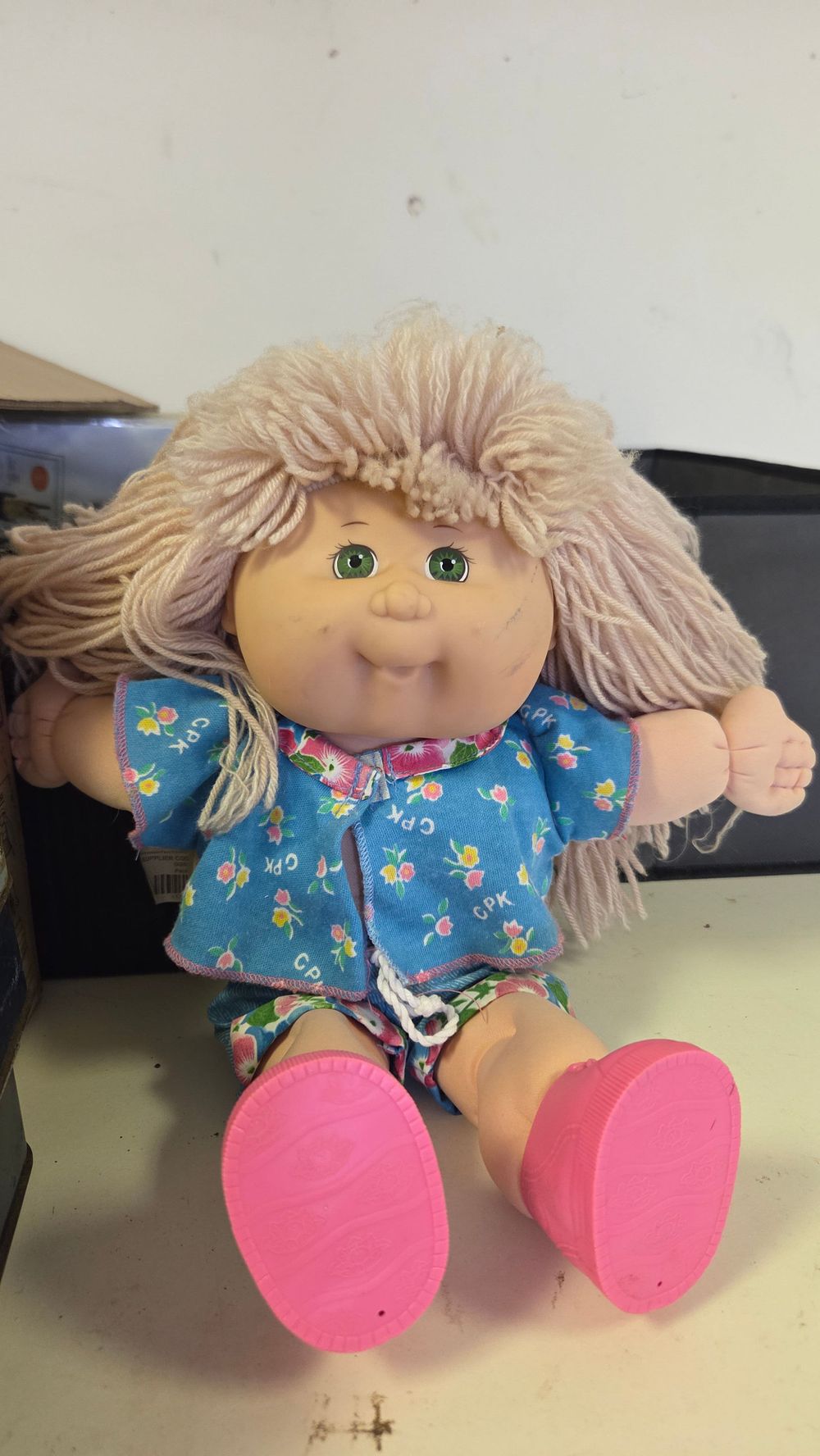 Lot 203 – Cabbage Patch Kids Doll with Yarn Hair and Blue Floral Outfit