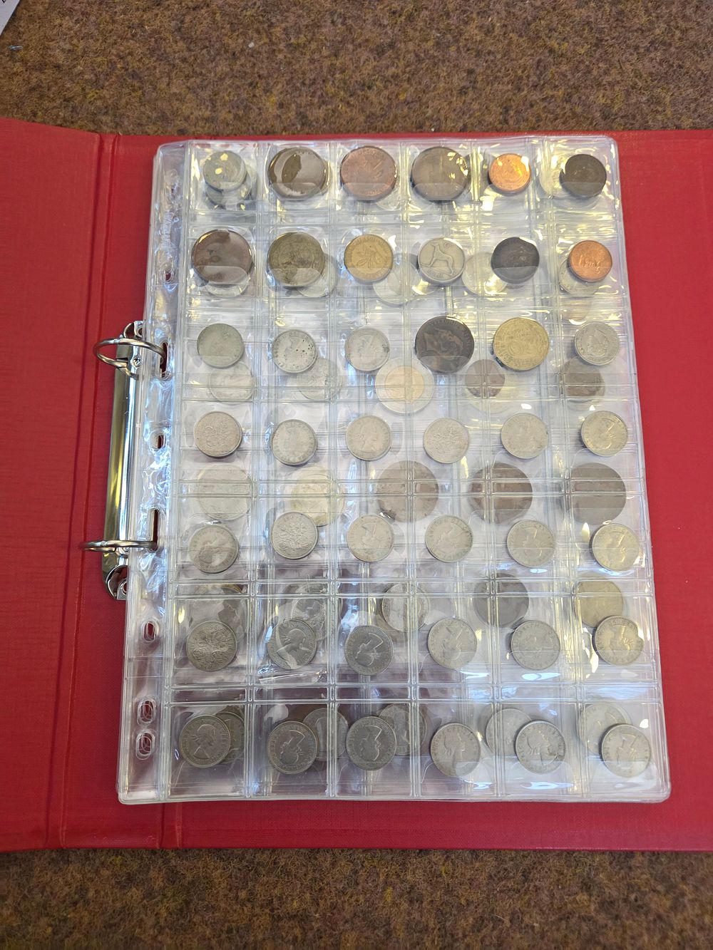 Lot 607 – A Collection of International Coins in a Binder including UK, British Commonwealth, and World Issues
