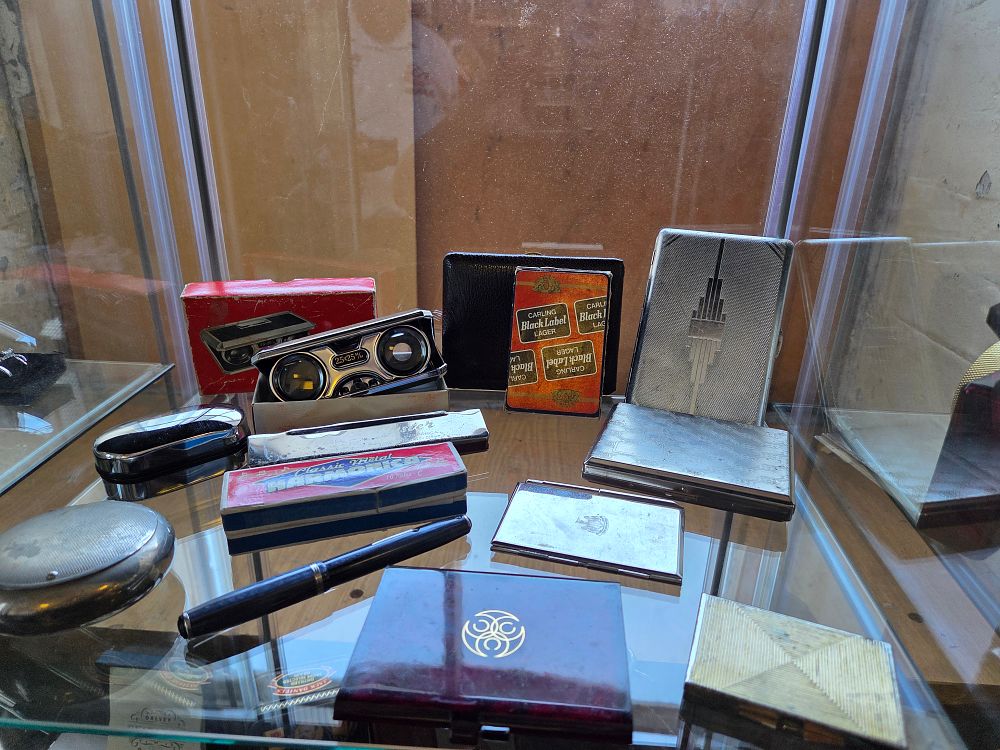 Lot 614 – An Assortment of Vintage Personal Accessories and Curiosities including Art Deco Cases, Opera Glasses, and Harmonica