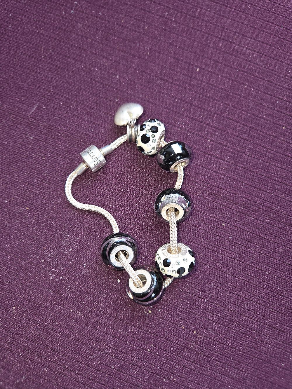 Lot 642 – A Rhona Sutton Sterling Silver Modular Charm Bracelet with Glass Beads and Heart Charm 22.28g