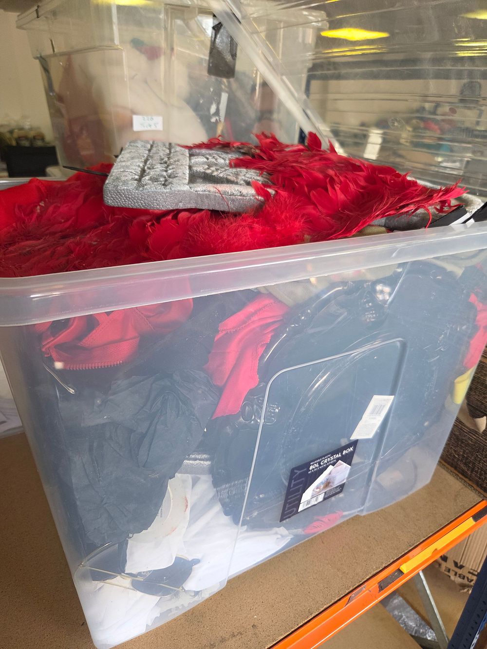 Lot 228 – A Collection of Theatrical Costumes, Props, and a Large Plastic Storage Bin