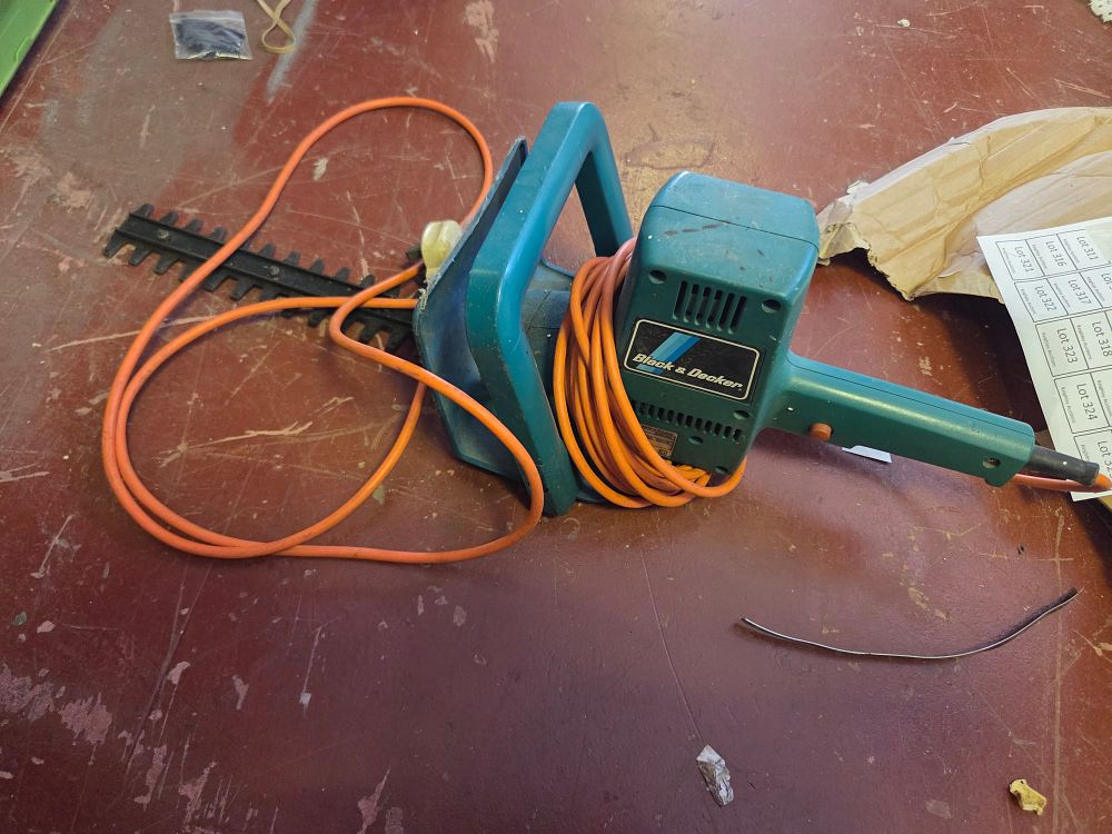 Lot 309 – A Black & Decker Corded Electric Hedge Trimmer powers on
