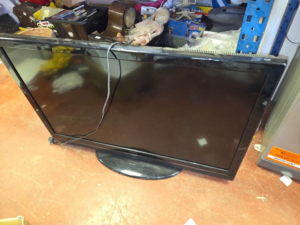 Lot 390 – One Hitachi L42VC04U 42-inch Full HD LCD Television With Stand and Remote powers on