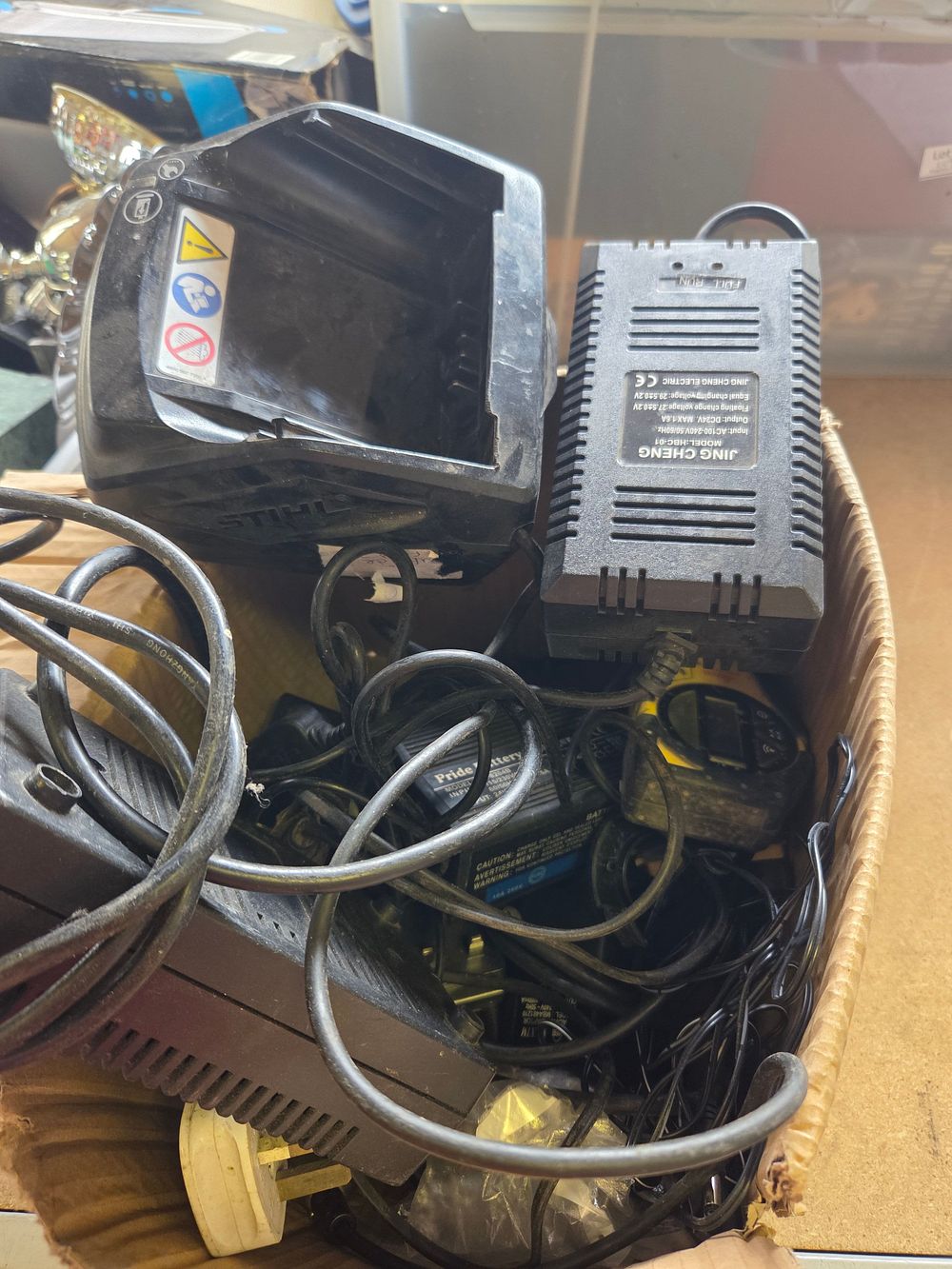 Lot 176 – One Box of Power Adapters and Battery Chargers Including STIHL and Pride Mobility