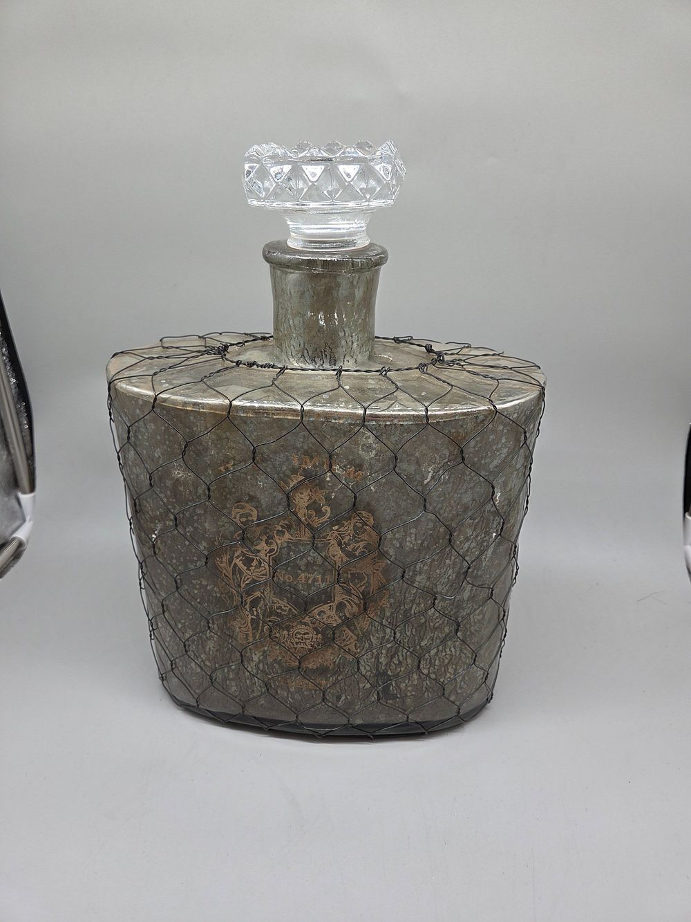 Lot 158 – Large Mercury Glass Decanter with Wire Netting and Faceted Stopper