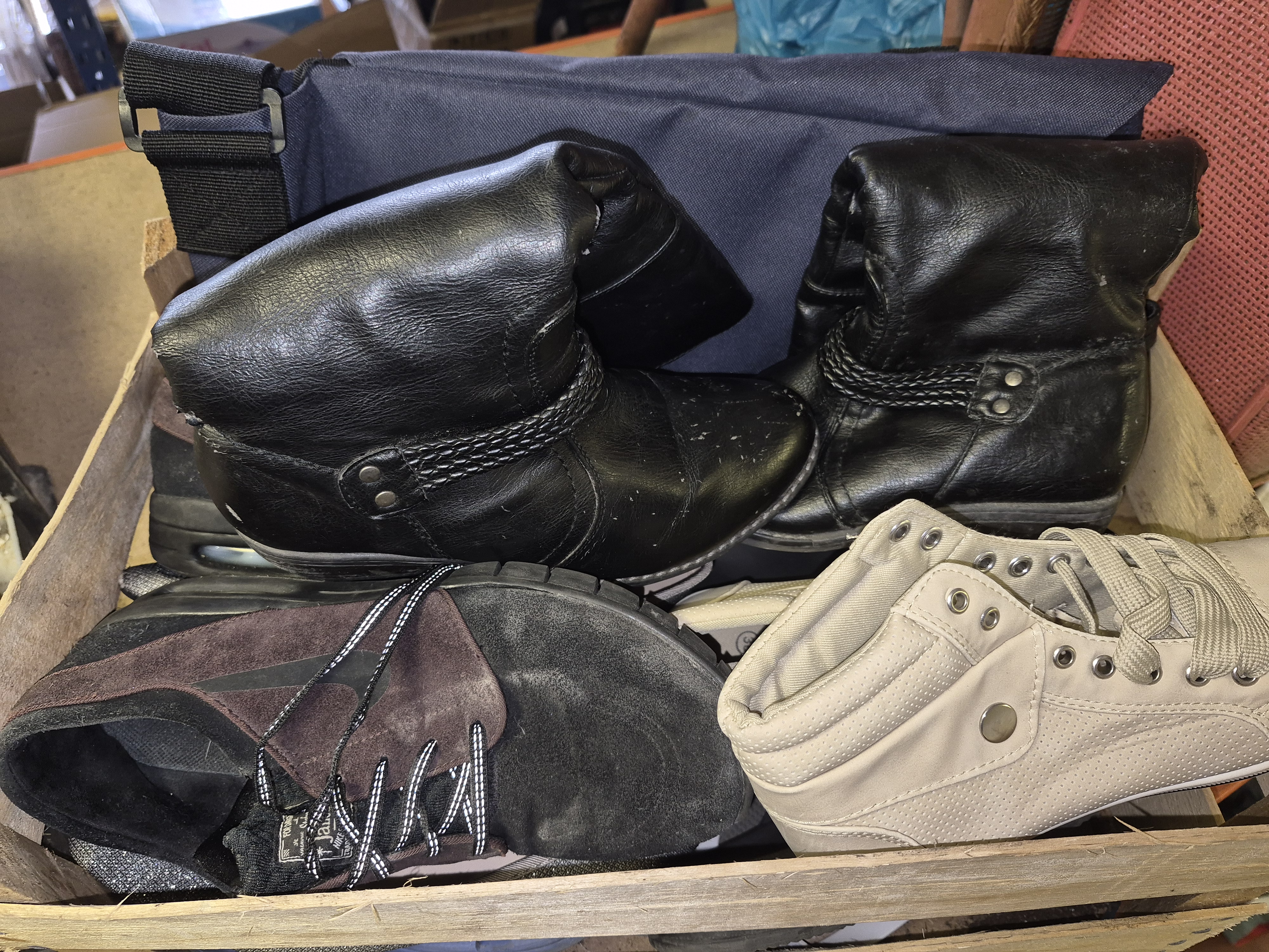 Crate of Contemporary Footwear Including a Pair of Black Ankle Boots