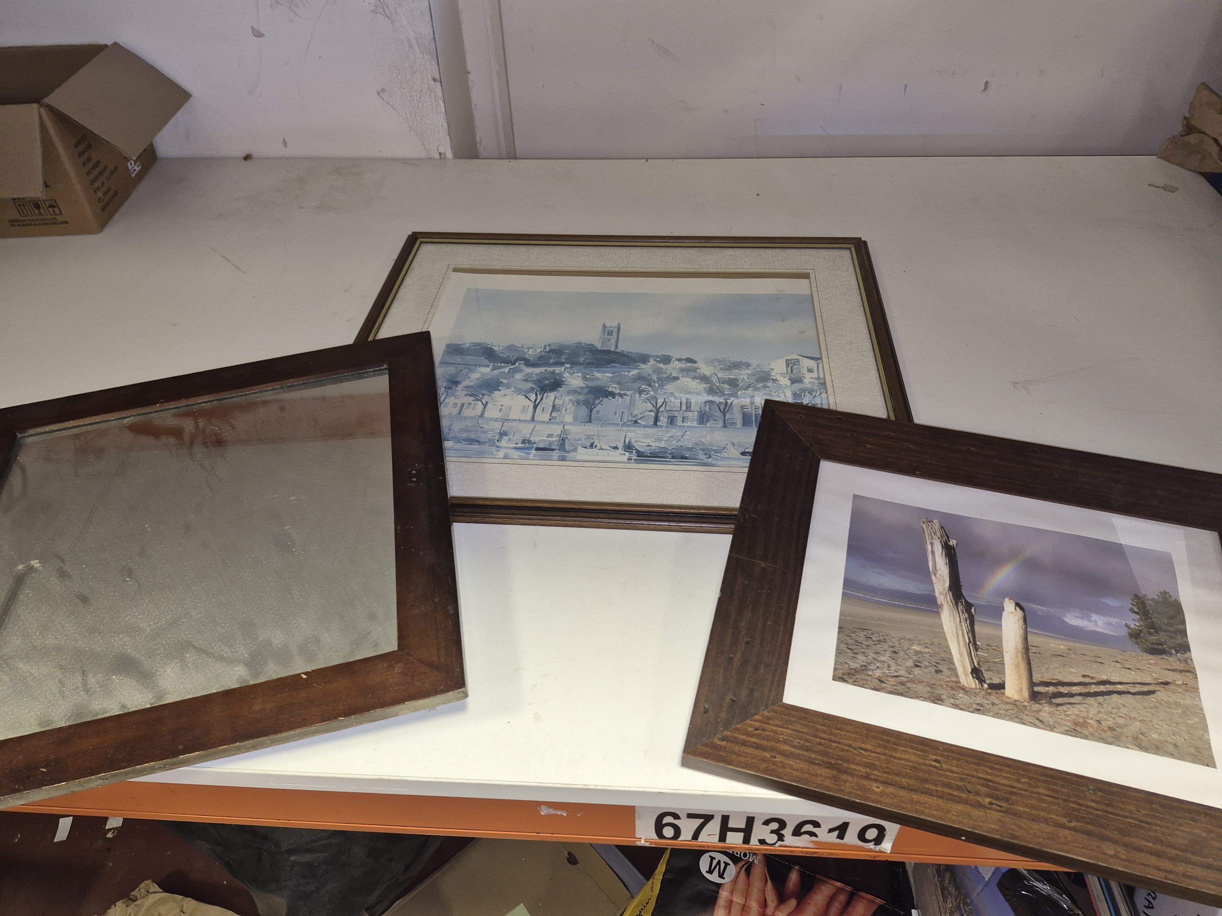 A Selection of Framed Artworks and a Rectangular Mirror