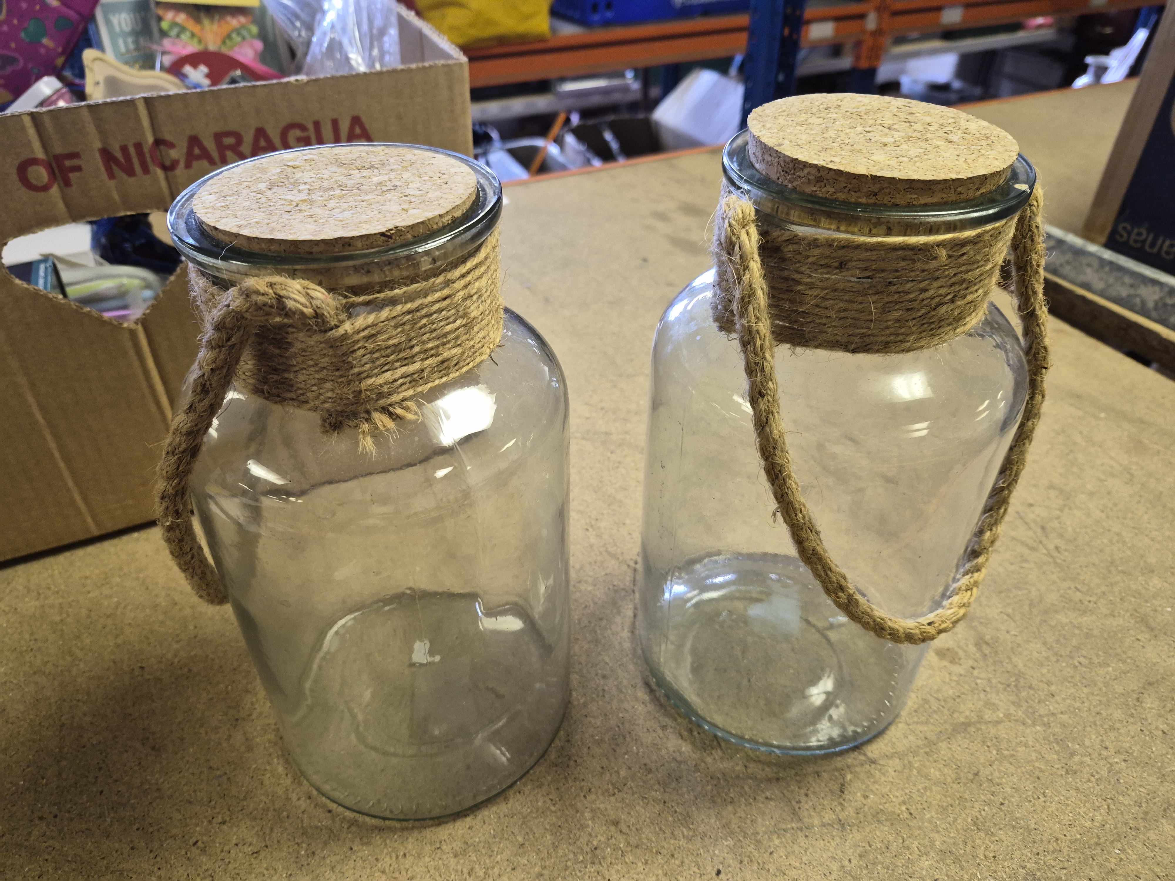 A Pair of Decorative Glass Jars with Rope Wrapped Necks and Cork Stoppers