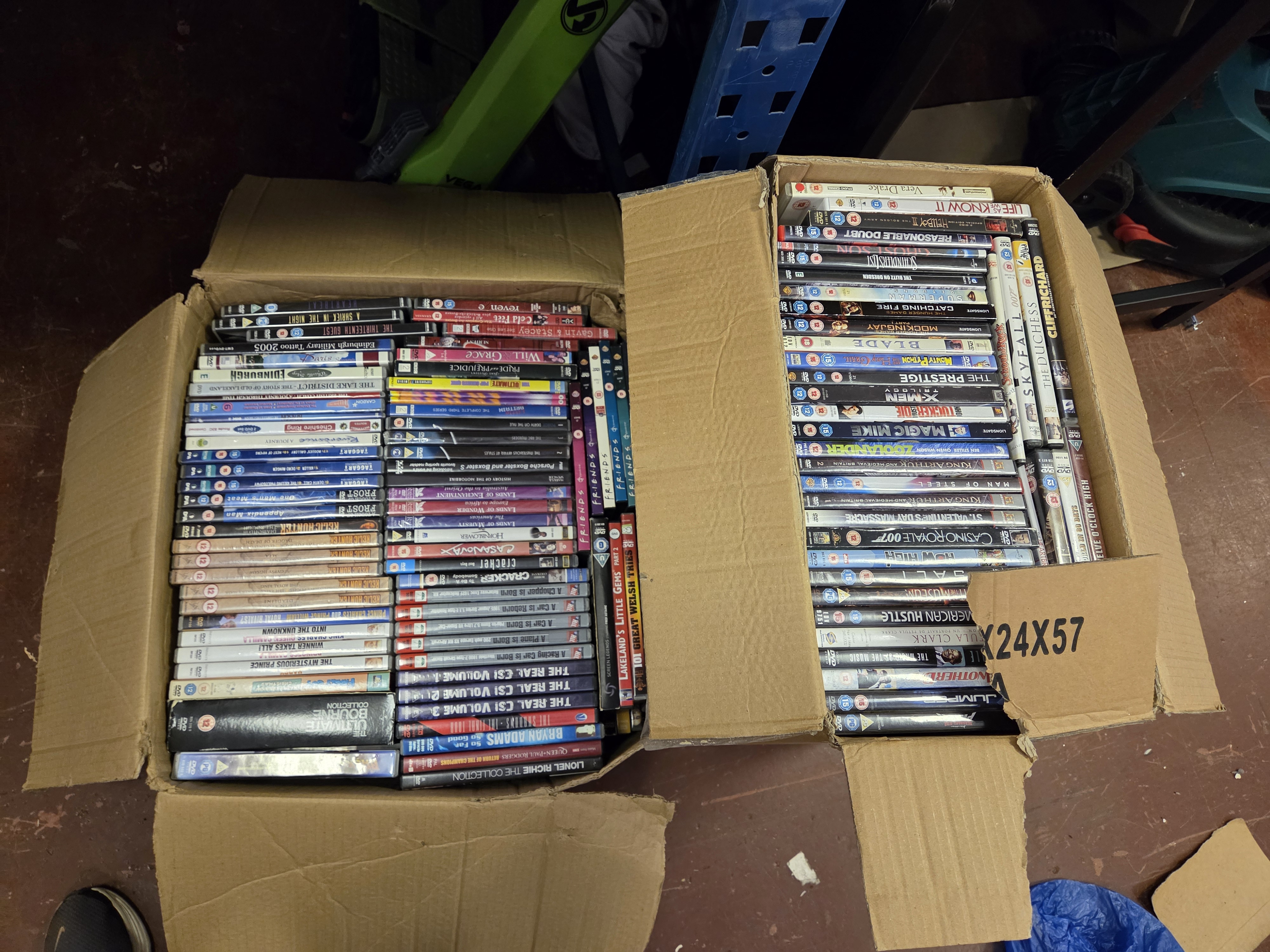 Two Boxes of Assorted DVDs Including The Bourne Ultimate Collection and James Bond