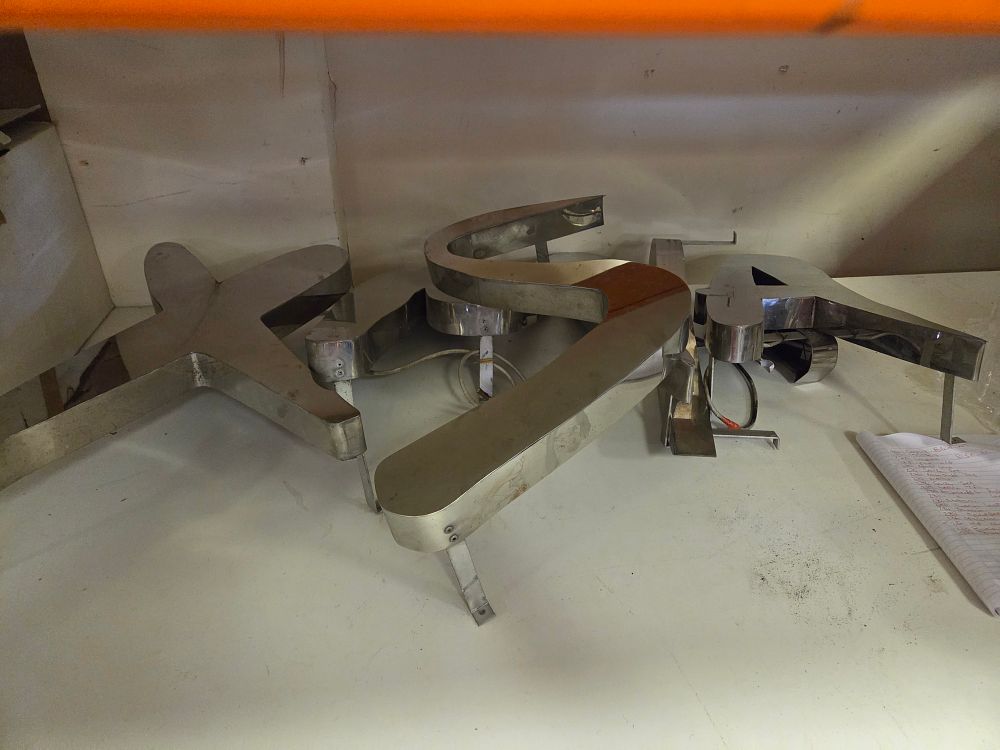 Lot 289 – A Collection of Polished Stainless Steel Signage Letters – can spell Xmas