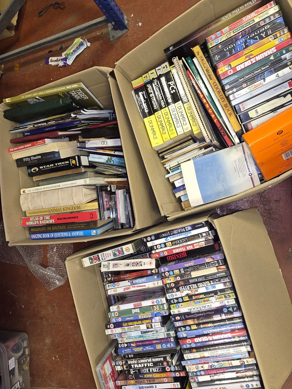 Lot 62 – Three Boxes of Assorted DVDs, Books, and Computer Software Including Commodore Manual