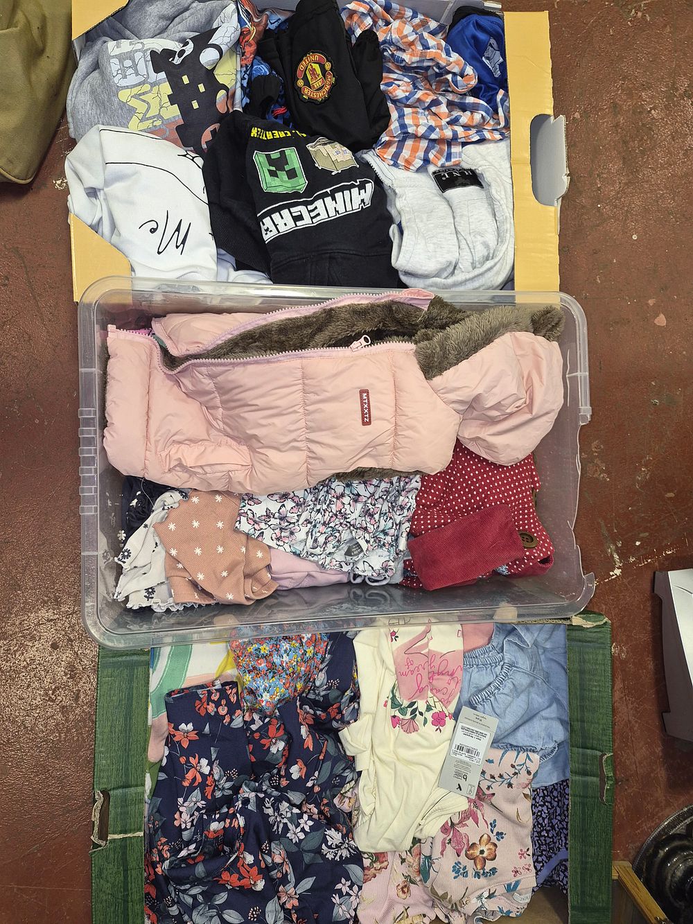 Lot 68 – Three Boxes of Children’s Clothing Including Minecraft and Manchester United Items some with tags