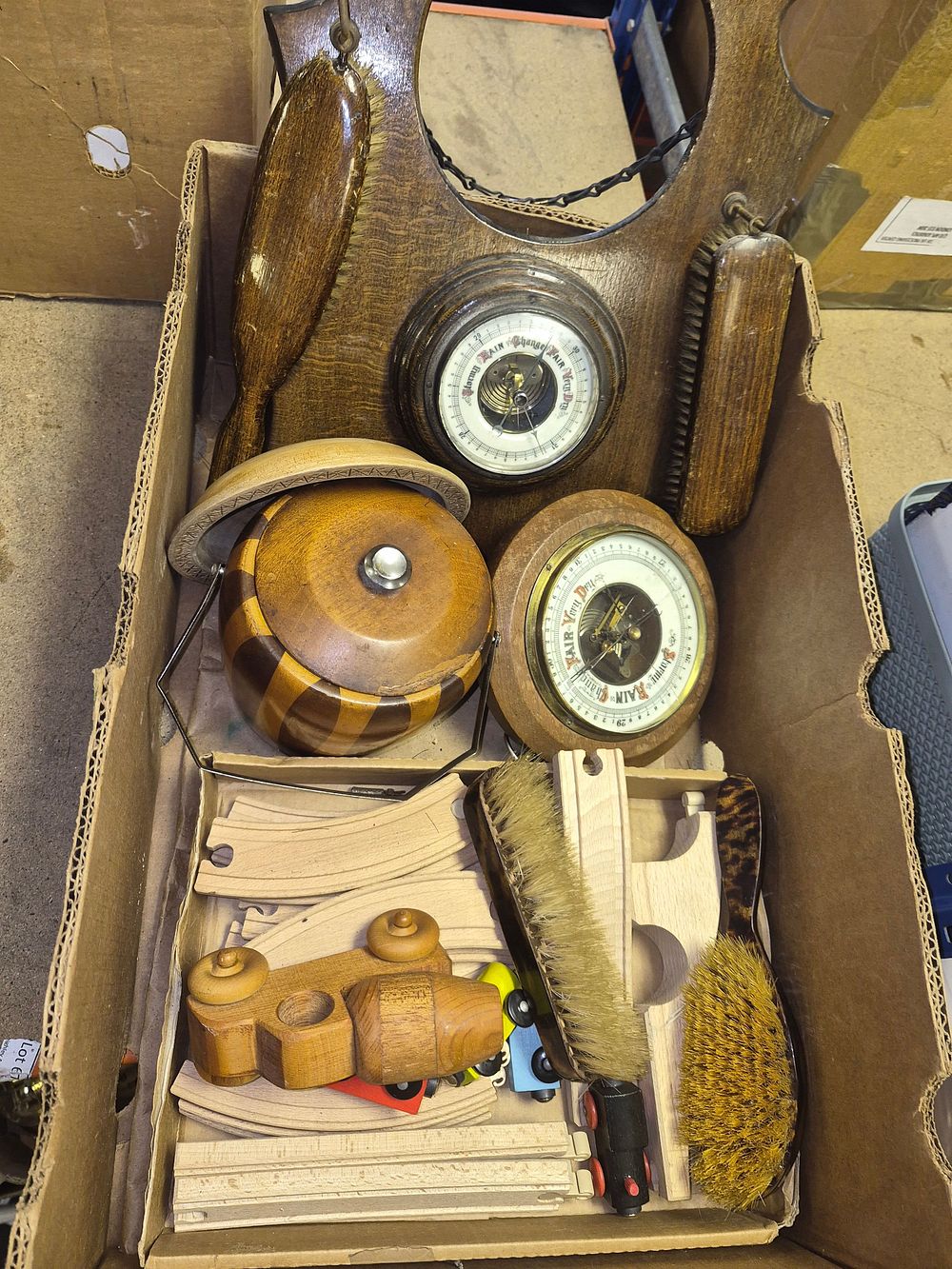 Lot 46 – A Collection of Vintage Domestic Items Including Barometer and Brush Sets, a Biscuit Barrel, and Wooden Railway Toys