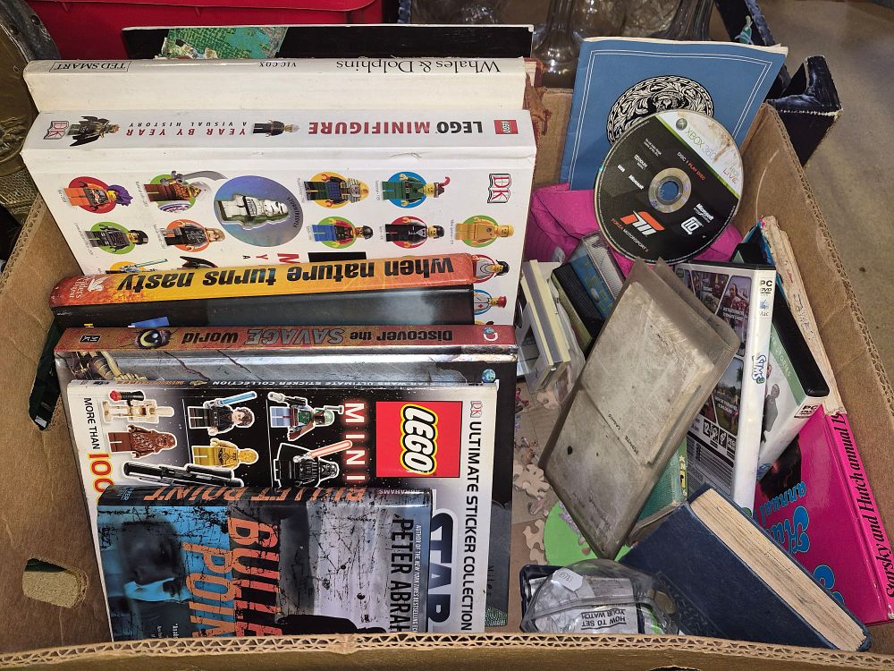 Lot 105 – Box of Books, Media, and Miscellaneous Items Including LEGO Minifigure Year by Year