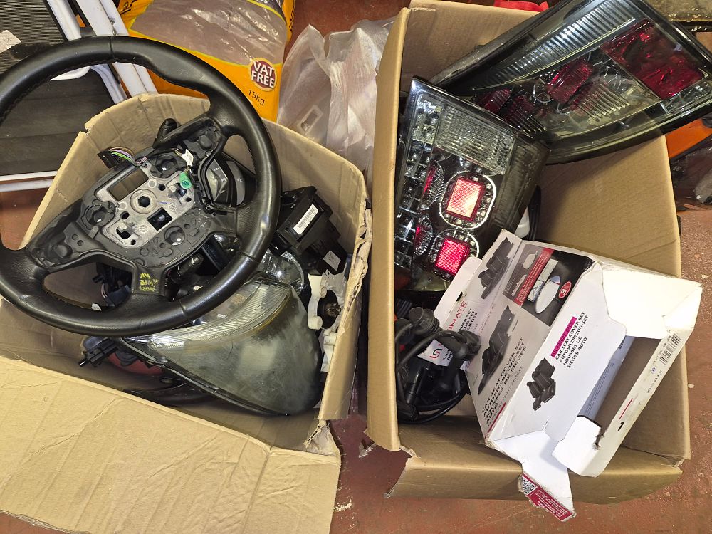 Lot 212 – Two Boxes of Mixed Auto Parts and Accessories Including Audi TT Tail Lights, Focus Headlight and Steering Wheel