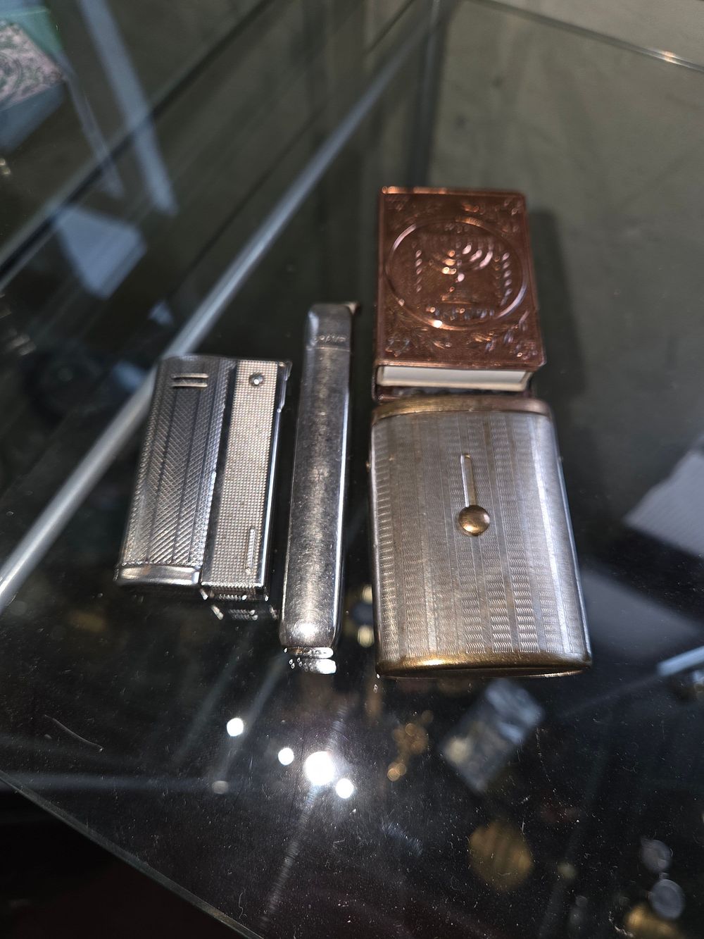 Lot 604 – A Group of Vintage Lighters and Matchbox Holders