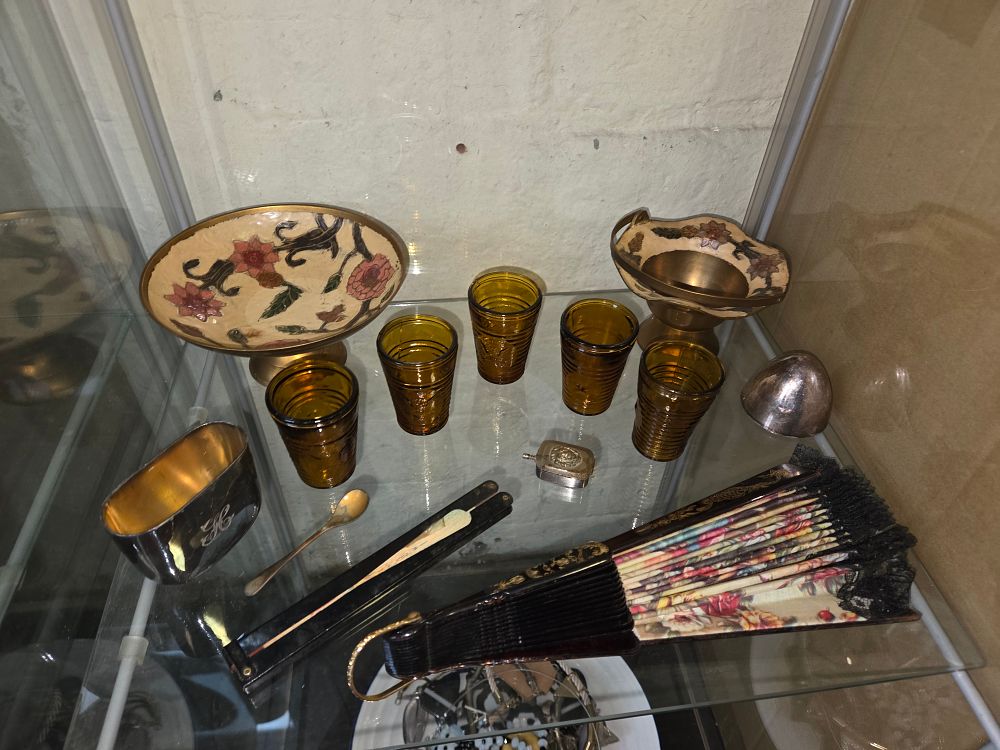 Lot 635 – A Group of Decorative Metalware, Amber Glassware, and Folding Hand Fans