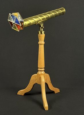 Brass Kaleidoscope on Wooden Tripod Stand Brass kaleidoscope with two glass panes, one stained 