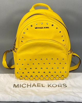 A Michael Kors Yellow 'Erin' Small Studded Backpack. A Michael Kors 'Erin' Small Studded 