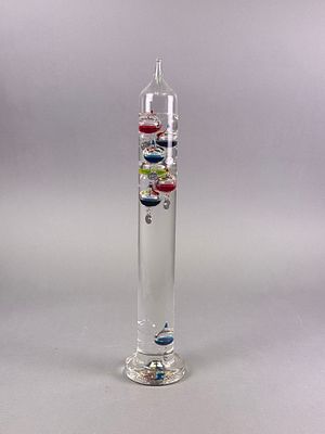 A Tall Glass Galileo Thermometer with Multicolor Floating Bulbs. A Galileo thermometer, crafted 
