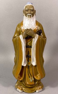 A Chinese Dehua Glazed Ceramic Figure of a Sage. A Chinese Dehua glazed ceramic figure depicting 