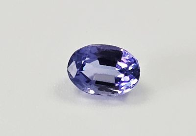 A 1.52-Carat Oval-Cut Tanzanite Gemstone. This faceted violet-blue gemstone is identified as a 