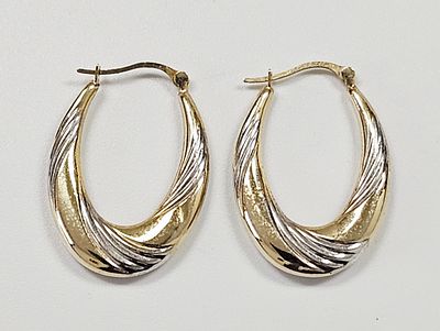 A Pair of 14k Two-Tone Gold Shrimp Style Hoop Earrings. A pair of 14k two-tone gold hoop 