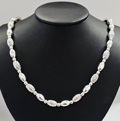 Sterling Silver Filigree and Polished Bead Necklace. This sterling silver necklace features an 