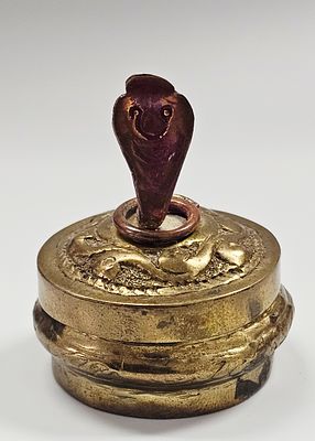 A 20th Century South Asian Brass and Copper Decorative Box with Cobra Finial. A small, circular 