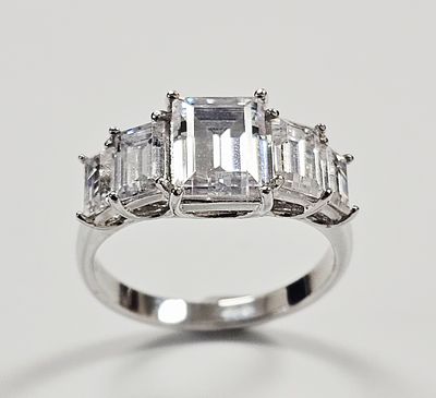 A Sterling Silver and Cubic Zirconia Five-Stone Ring. A sterling silver ring by PAJ featuring a 