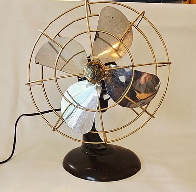 A General Electric 12 Inch Stationary Brass Bladed Desk Fan. A General Electric stationary 