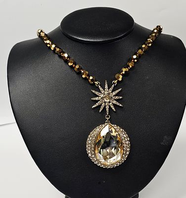Heidi Daus Star and Pear Pendant Beaded Necklace. A gold-tone necklace featuring 