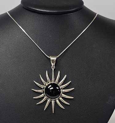 Sterling Black Onyx Sunburst Pendant Necklace 24.9 Grams. This jewelry lot features a sterling 