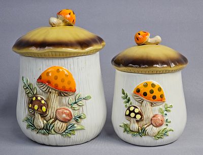 Pair of Merry Mushroom Ceramic Canisters. This pair of graduated ceramic canisters is part of 